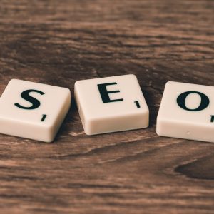 Scrabble tiles spelling SEO on a wooden surface. Ideal for digital marketing themes.